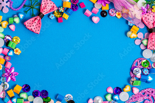 Mix of beads and beads on a blue background. The formation border is a frame with a blue color for the text. Mockup and abstract, colorful background. concept of needlework, creativity and a hobby.