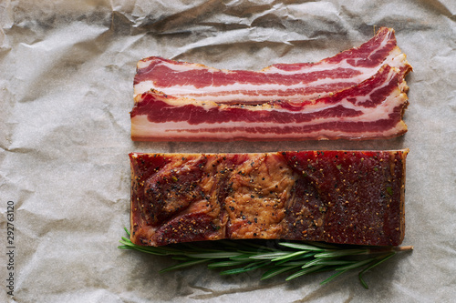 Smoked italian pancetta meat on paper top view