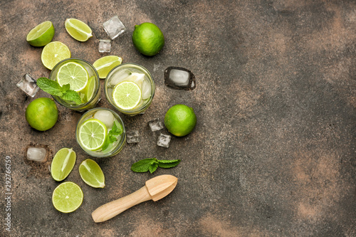 Glasses of fresh mojito on grey background