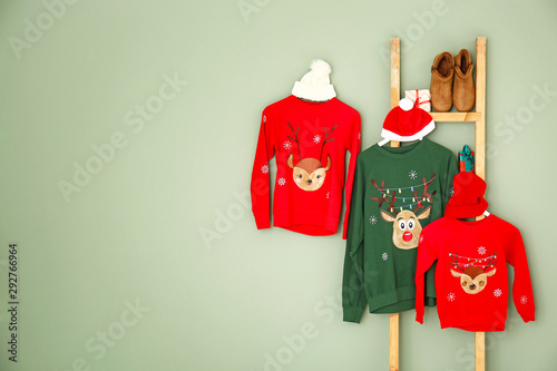 Set of family Christmas clothes on color background photo