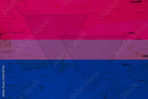 A rustic old bisexual flag on weathered wood photo