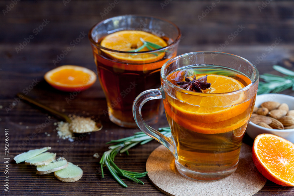 Two cups of hot tea with oranges, closeup Two cups of hot tea with oranges, closeup