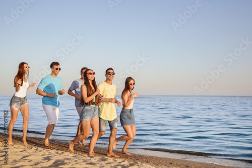 Happy young friends running...