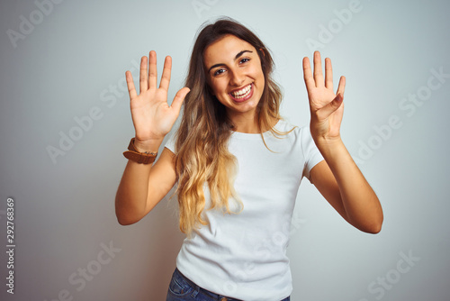 Young beautiful woman wearing casual white t-shirt over isolated background showing and pointing up with fingers number nine while smiling confident and happy.