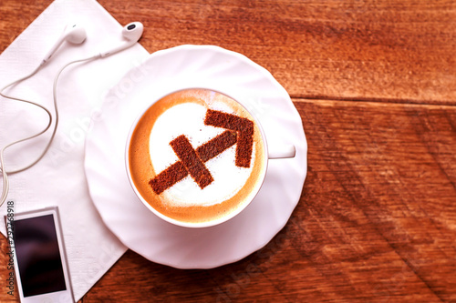 white cup of coffee with the symbol of the zodiac