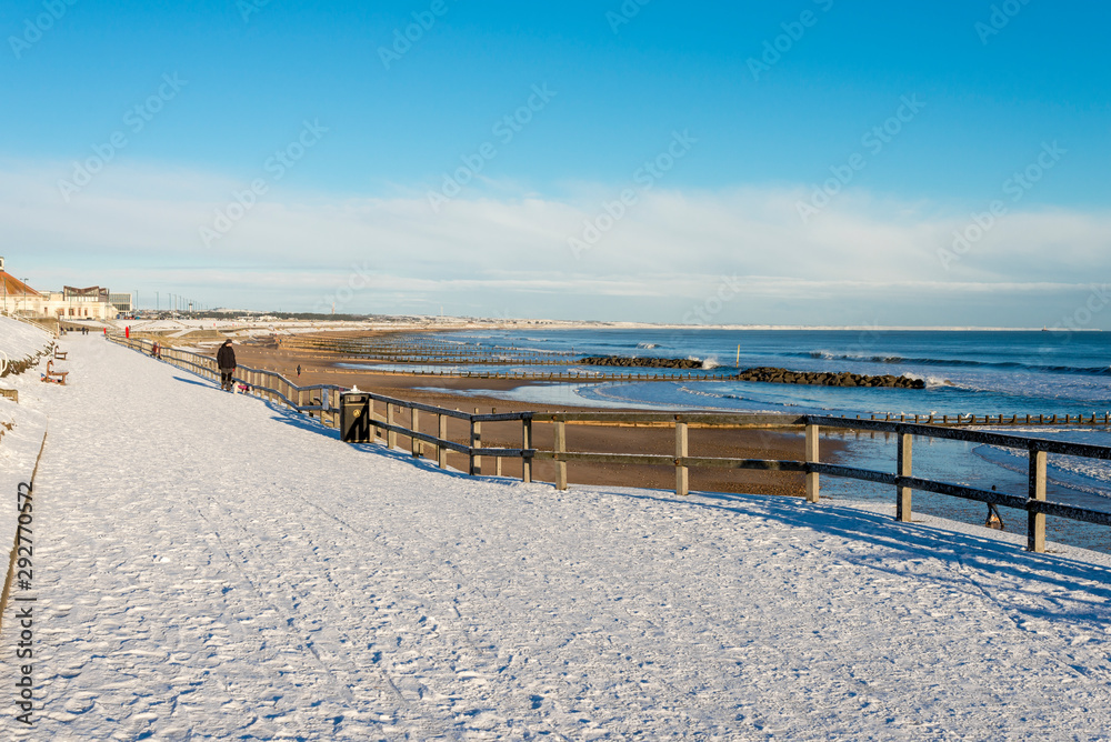 Promenade walk along Aberdeen city beach covered by snow, Scotland