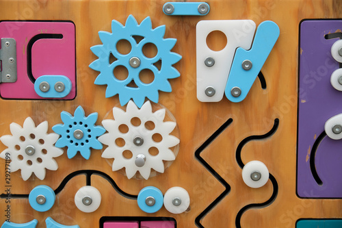 children's educational toys. Wooden multi-colored game Board with gears and runners