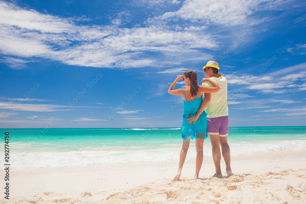 Beach couple walking on romantic travel honeymoon vacation summer holidays romance. Young happy lovers, Cayo LArgo, Cuba Beach couple walking on romantic travel honeymoon vacation summer holidays romance. Young happy lovers, Cayo LArgo, Cuba