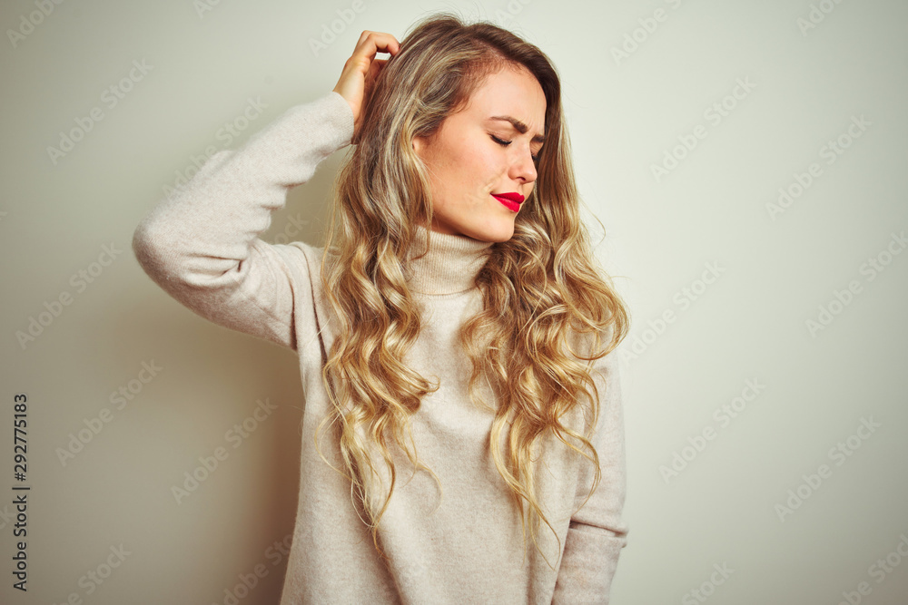 Beautiful woman wearing winter turtleneck sweater over isolated white background confuse and wondering about question. Uncertain with doubt, thinking with hand on head. Pensive concept. Beautiful woman wearing winter turtleneck sweater over isolated white background confuse and wondering about question. Uncertain with doubt, thinking with hand on head. Pensive concept.