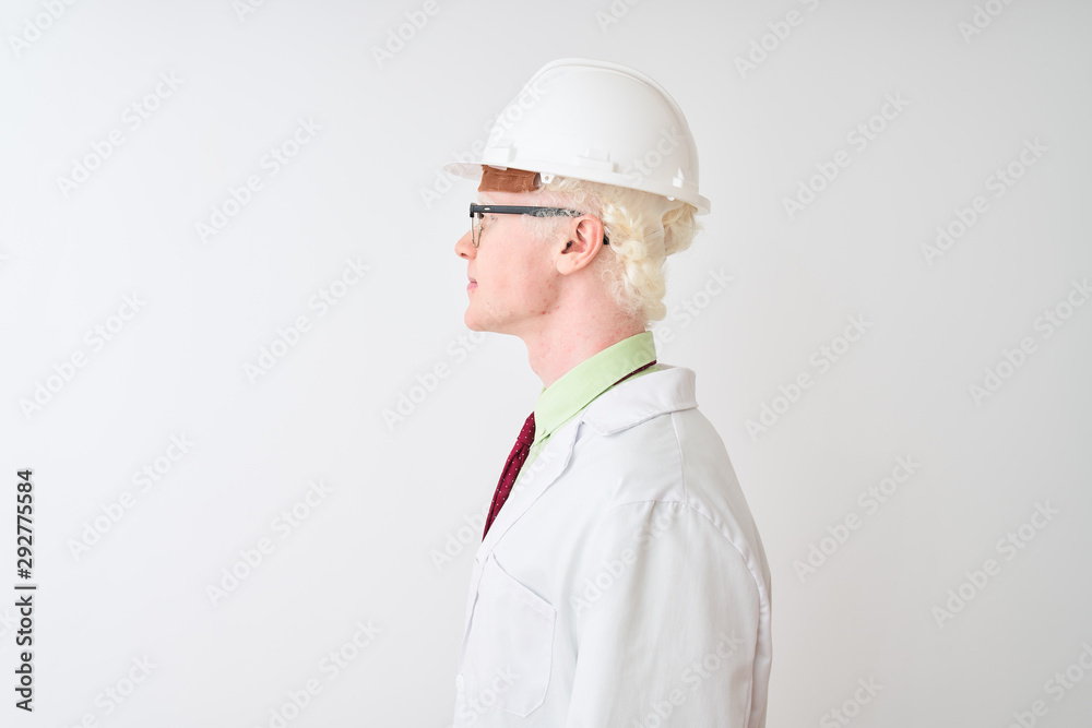Albino scientist man wearing glasses and helmet standing over isolated white background looking to side, relax profile pose with natural face with confident smile. Albino scientist man wearing glasses and helmet standing over isolated white background looking to side, relax profile pose with natural face with confident smile.