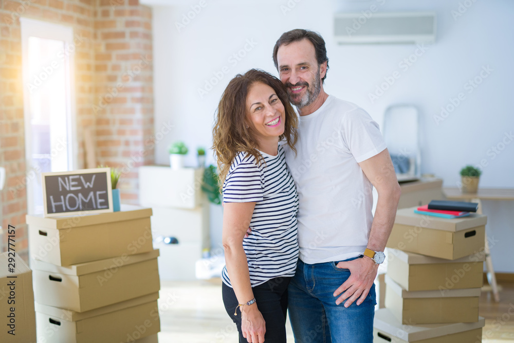 Middle age senior couple moving to a new house, smiling happy in love with apartmant Middle age senior couple moving to a new house, smiling happy in love with apartmant