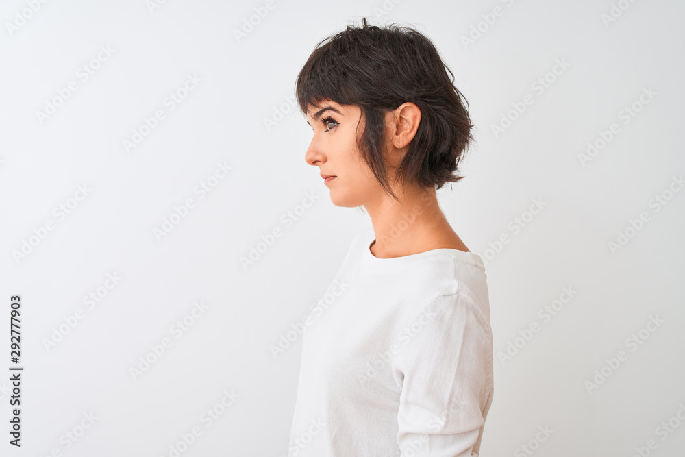 Young beautiful woman wearing casual t-shirt standing over isolated white background looking to side, relax profile pose with natural face with confident smile. Young beautiful woman wearing casual t-shirt standing over isolated white background looking to side, relax profile pose with natural face with confident smile.