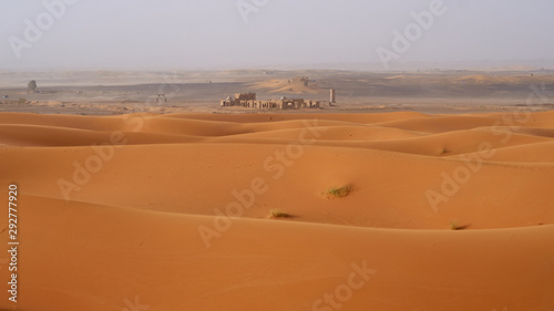 Abandoned ruins in Sahara desert, landscape with a beautiful sand dunes in Morocco. 