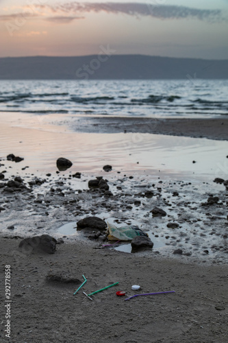 Fototapeta Naklejka Na Ścianę i Meble -  Plastic Trash Found on the Beach, Sea of Galilee, Sunset, Israel