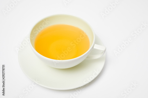 Herbal tea in a white cup isolated on white