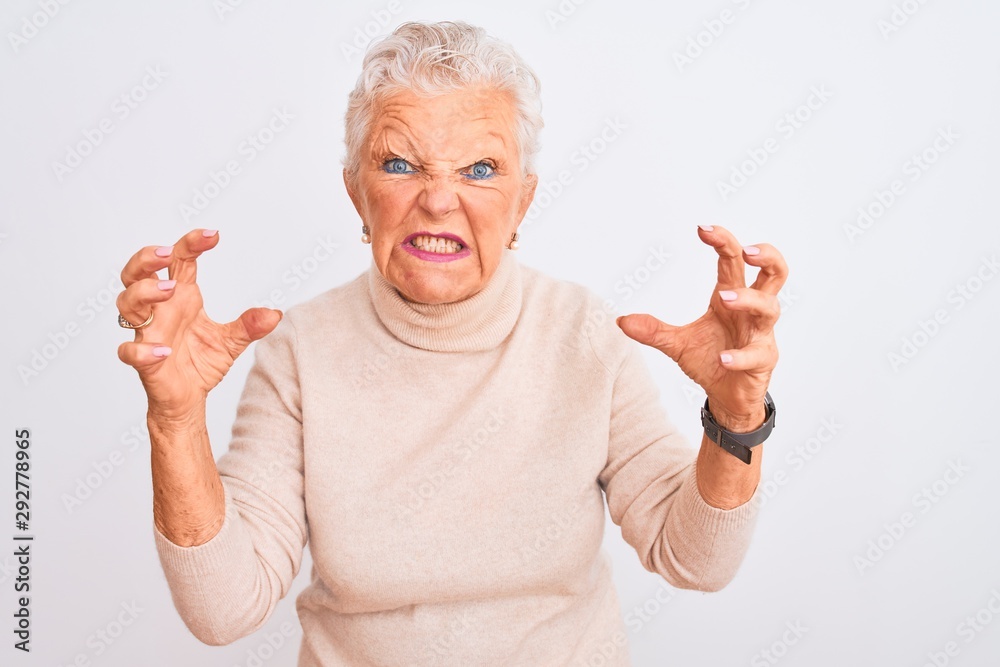 Senior grey-haired woman wearing turtleneck sweater standing over isolated white background Shouting frustrated with rage, hands trying to strangle, yelling mad Senior grey-haired woman wearing turtleneck sweater standing over isolated white background Shouting frustrated with rage, hands trying to strangle, yelling mad
