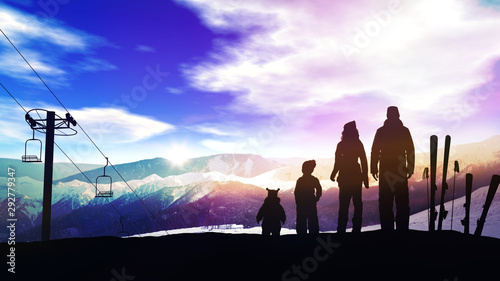 Family on a ski slope at sunset.