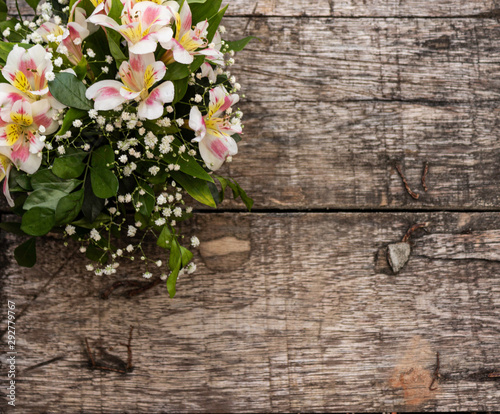 White flowers on wooden background, left nd top position