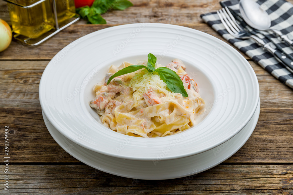 fettuccine with salmon on wooden table fettuccine with salmon on wooden table