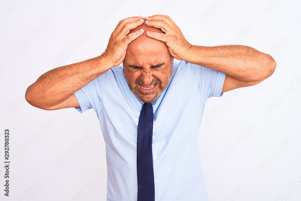 Middle age businessman wearing tie standing over isolated white background suffering from headache desperate and stressed because pain and migraine. Hands on head. Middle age businessman wearing tie standing over isolated white background suffering from headache desperate and stressed because pain and migraine. Hands on head.