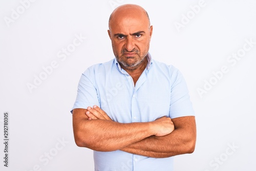 Middle age handsome man wearing casual shirt standing over isolated white background skeptic and nervous, disapproving expression on face with crossed arms. Negative person. © Krakenimages.com