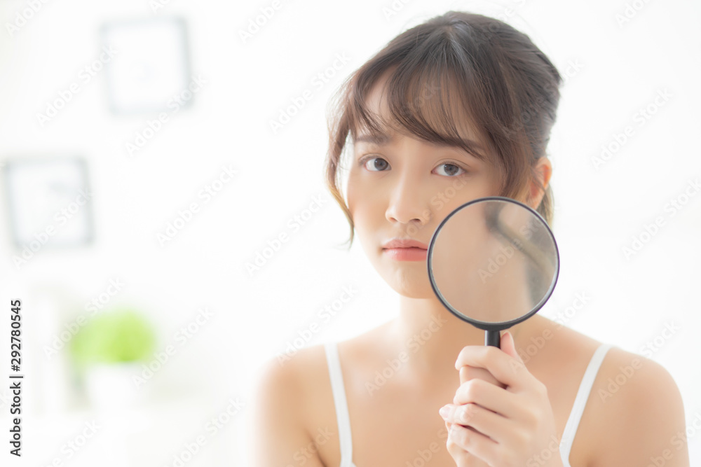 Beautiful young asian woman with magnifying of skin a problem of acne, beauty asia girl check skincare of face, female analyzing trouble, cosmetic and makeup, health and care concept. Beautiful young asian woman with magnifying of skin a problem of acne, beauty asia girl check skincare of face, female analyzing trouble, cosmetic and makeup, health and care concept.