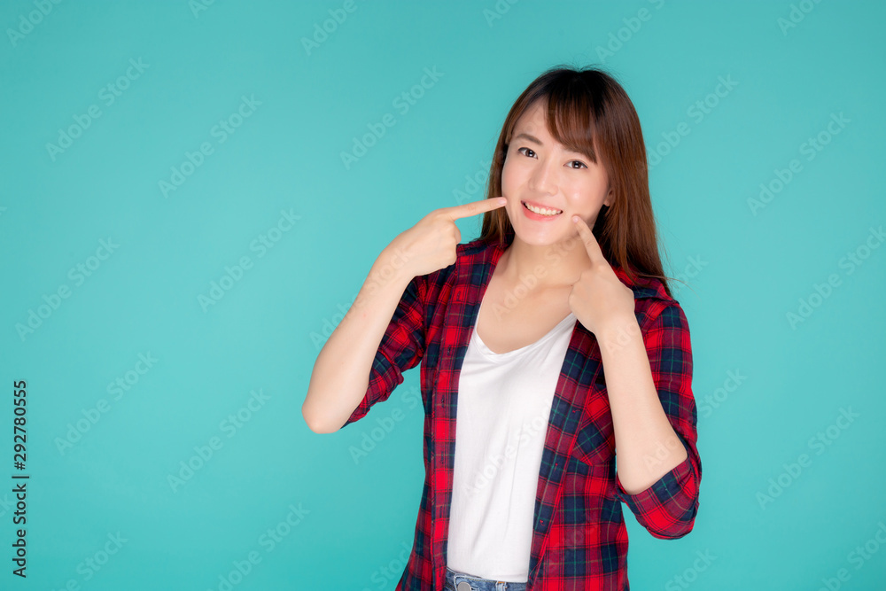 Beautiful portrait young asian woman smiling confident and excited summer holiday isolated blue background, beauty asia girl enjoy and cheerful with pointing cheek journey, travel concept. Beautiful portrait young asian woman smiling confident and excited summer holiday isolated blue background, beauty asia girl enjoy and cheerful with pointing cheek journey, travel concept.