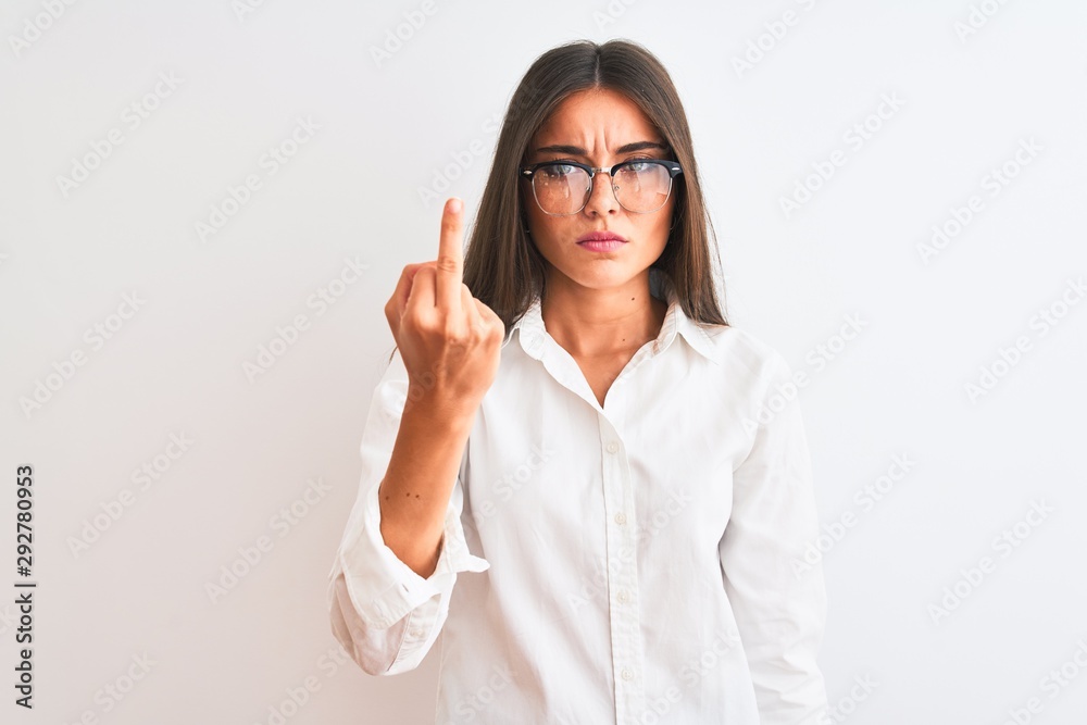Young beautiful businesswoman wearing glasses standing over isolated white background Showing middle finger, impolite and rude fuck off expression Young beautiful businesswoman wearing glasses standing over isolated white background Showing middle finger, impolite and rude fuck off expression