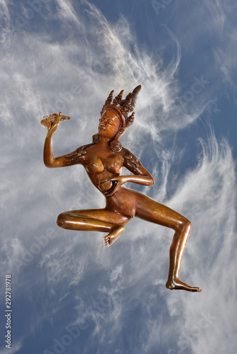 Tibetan Statue Yogini ascending into clouds photo