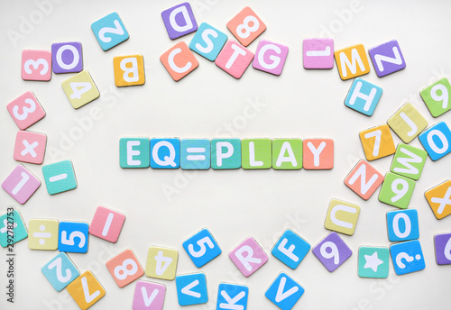 Multi-color Alphabet ABC letters and number and mathematics sign in square flat papers on white background with EQ = PLAY at center.