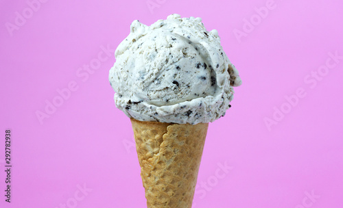 Strawberry ice cream scoop in cone on pink background, Closeup Front view Food concept..