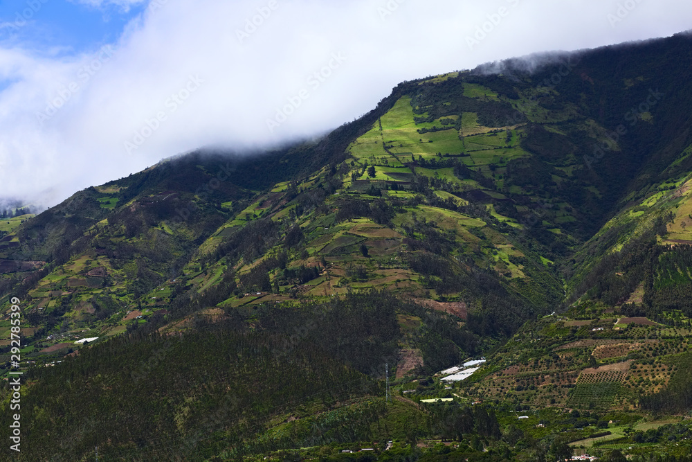 Rural hillside landscape with forests, small farms and orchards along the road between Ambato and Banos in Tungurahua Province in Central Ecuador