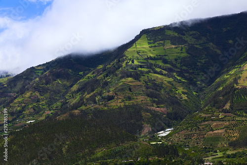 Rural hillside landscape with forests, small farms and orchards along the road between Ambato and Banos in Tungurahua Province in Central Ecuador