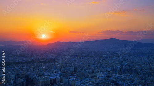 Panorama of Athens at sunset. Beautiful cityscape with seashore under the red sunset sky. Travel panoramic photography view over the city at night from Lycabettus hill. Athens skyline, Greece Europe. © raisondtre