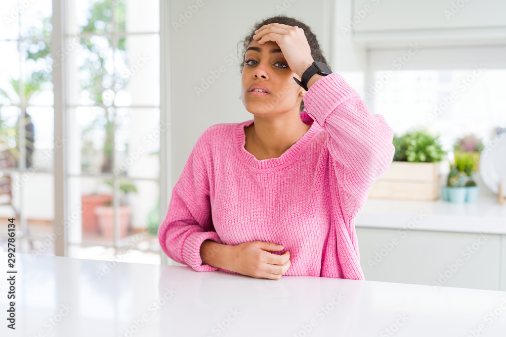 Beautiful african american woman with afro hair wearing casual pink sweater Touching forehead for illness and fever, flu and cold, virus sick Beautiful african american woman with afro hair wearing casual pink sweater Touching forehead for illness and fever, flu and cold, virus sick