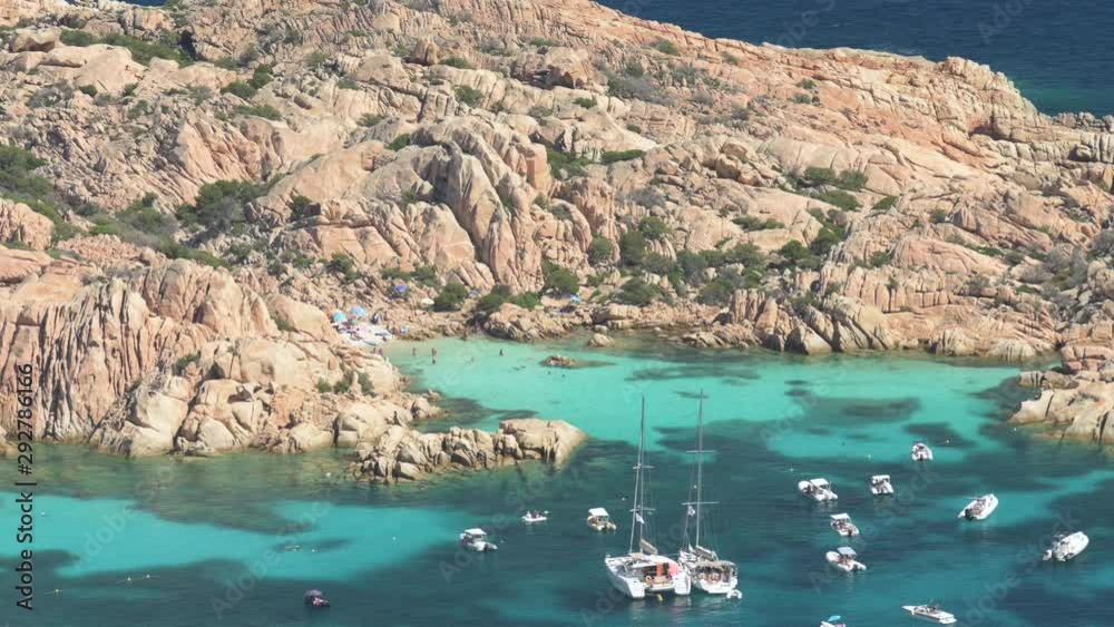 View from above, stunning aerial view of Cala Coticcio also known as Tahiti with boats and yachts floating on a turquoise clear water. La Maddalena Archipelago, Sardinia, Italy. View from above, stunning aerial view of Cala Coticcio also known as Tahiti with boats and yachts floating on a turquoise clear water. La Maddalena Archipelago, Sardinia, Italy.