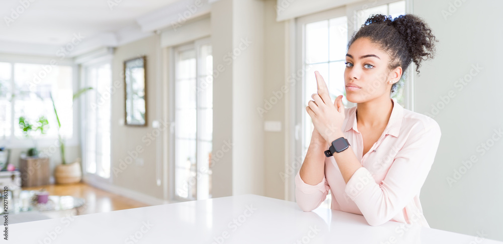 Wide angle of beautiful african american woman with afro hair Holding symbolic gun with hand gesture, playing killing shooting weapons, angry face Wide angle of beautiful african american woman with afro hair Holding symbolic gun with hand gesture, playing killing shooting weapons, angry face