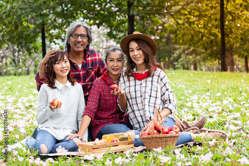 Senior Couple with two daughter in garden with many apples, they happy and smile, Family concept. - photo © MoJoeMoJo