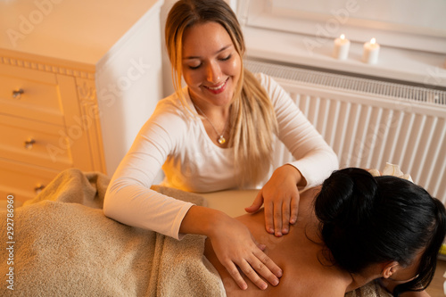 Pretty young masseuse  massaging woman, focus on hands 