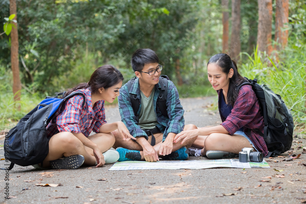 Group teens asian travel with backpack at spruce forest looking map the route go to destinations, Concept Travel Group teens asian travel with backpack at spruce forest looking map the route go to destinations, Concept Travel