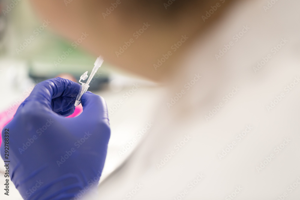 Close up of Scientist using pipette and test tube, examining samples and liquid in laboratory Close up of Scientist using pipette and test tube, examining samples and liquid in laboratory