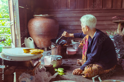 Portrait of Senior asian woman chef cook in the kitchen, Countryside in Thailand