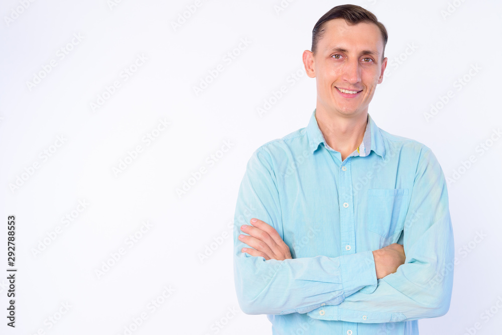 Studio shot of happy businessman smiling with arms crossed Studio shot of happy businessman smiling with arms crossed