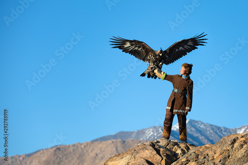 Traditional kazakh eagle huntress with her golden eagle that is used to hunt for fox and rabbit fur. Ulgii, Western Mongolia.