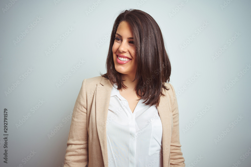 Young beautiful elegant business woman over isolated background looking away to side with smile on face, natural expression. Laughing confident. Young beautiful elegant business woman over isolated background looking away to side with smile on face, natural expression. Laughing confident.