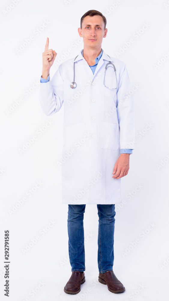 Full body shot of man doctor pointing up Full body shot of man doctor pointing up