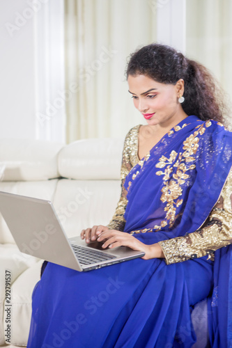 Traditional Indian woman working with a laptop