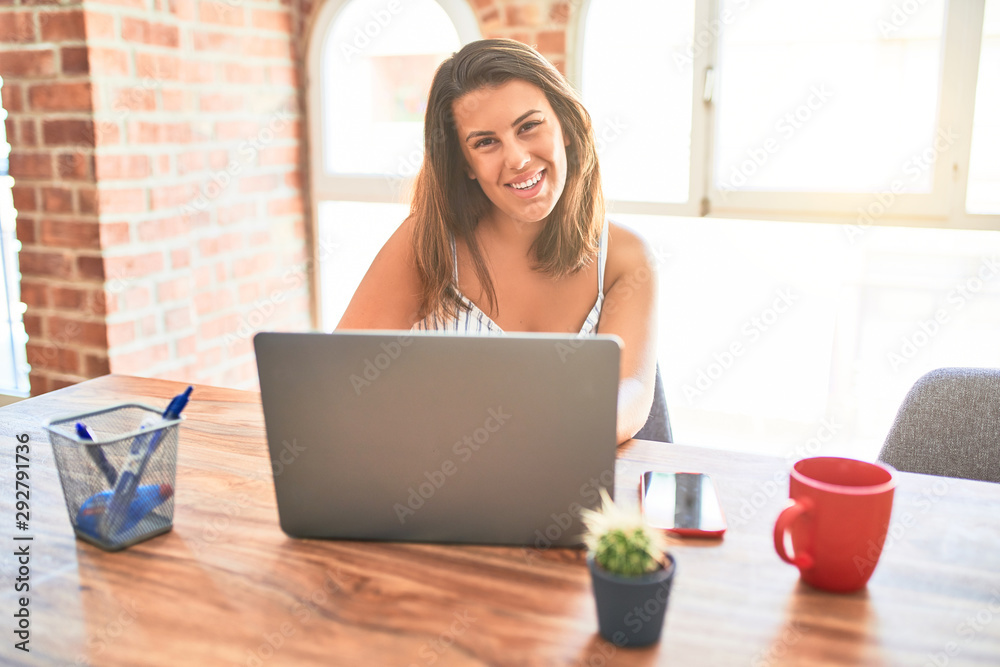 Young beautiful business woman working using laptop at home or the office, smiling positive Young beautiful business woman working using laptop at home or the office, smiling positive