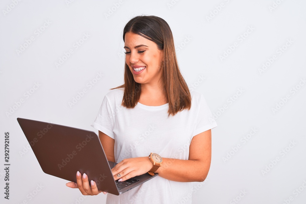 Beautiful young woman working using computer laptop over white background with a happy and cool smile on face. Lucky person. Beautiful young woman working using computer laptop over white background with a happy and cool smile on face. Lucky person.