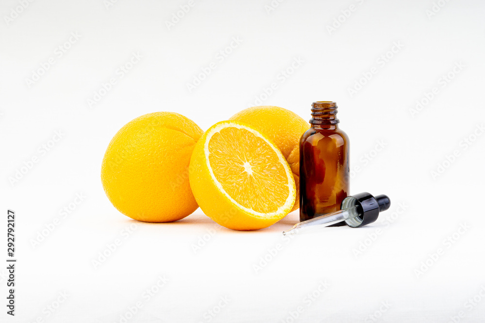 Vitamin C serum bottle with dropper and orange on white background.Health care concept and copy space Vitamin C serum bottle with dropper and orange on white background.Health care concept and copy space